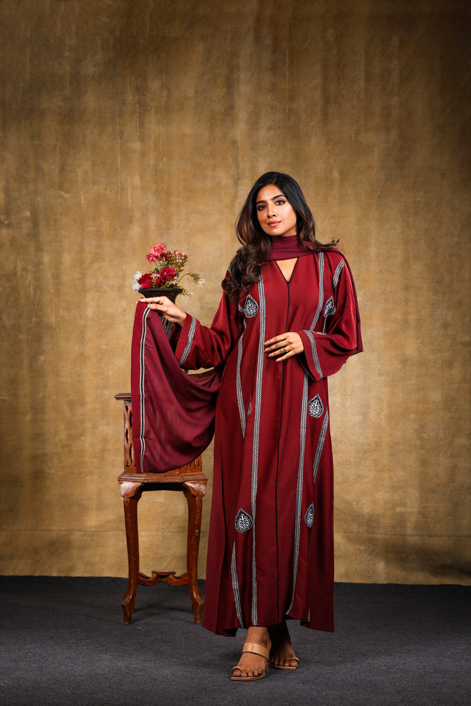 Maroon Front closed Abaya with contrast embroidery and multicoloured stones. Sizes 52-60.